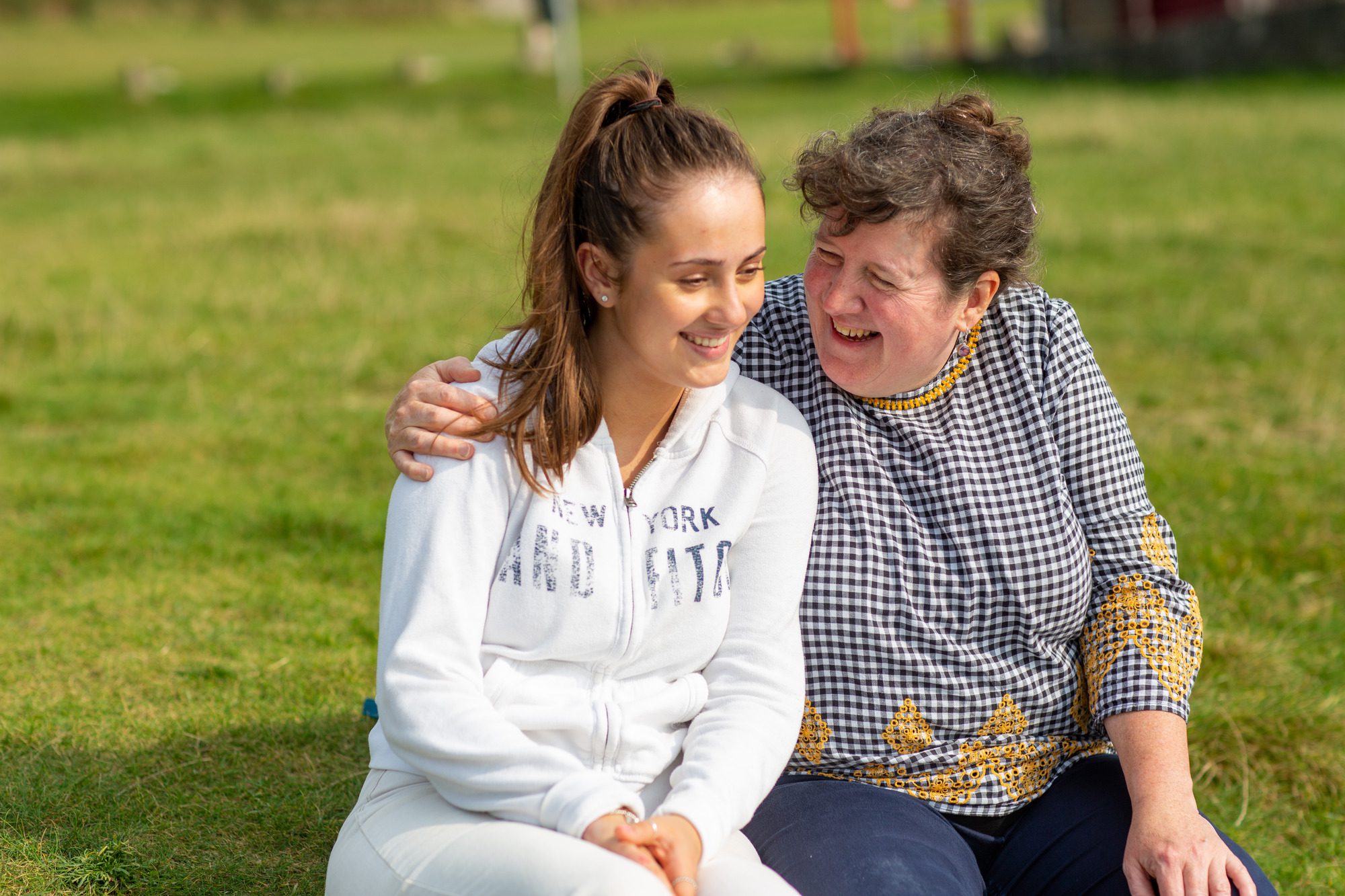 woman and child hugging and laughing